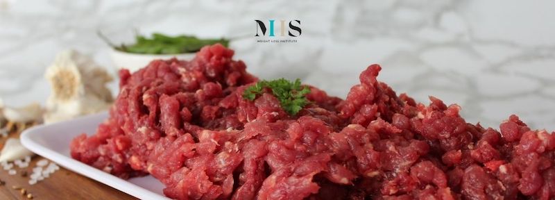 Meat substitute on a plate ready to be prepared as a plant based protein option, but is it a healthy option? MIIS Weight Loss Institute weighs in.
