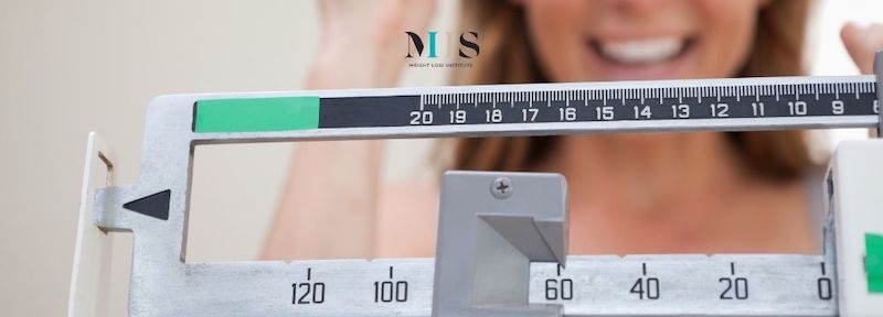 Woman weighs in excited about her progress after choosing the sleeve gastrectomy for weight loss surgery at MIIS Weight Loss Institute in St. Pete