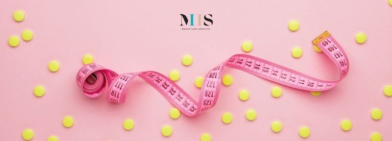 Weight loss medication scattered with tape measure as medical weight loss program patient tracks weight loss progress with MIIS Weight Loss Institute 